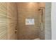 Walk-in shower with light brown tile and gold fixtures at 111 Gull Dr, Anna Maria, FL 34216