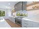 Modern kitchen with stainless steel appliances and a large window overlooking the water at 111 Gull Dr, Anna Maria, FL 34216