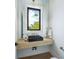 Modern powder room with a sleek sink and floating vanity at 111 Gull Dr, Anna Maria, FL 34216