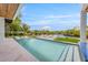 Inviting pool with lounge chairs, a hammock, and waterfront views at 111 Gull Dr, Anna Maria, FL 34216
