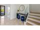 Bright entryway with marble floors, modern console table, and elegant staircase at 111 Gull Dr, Anna Maria, FL 34216