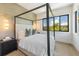 Elegant bedroom with a canopy bed and water views at 111 Gull Dr, Anna Maria, FL 34216