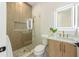Modern bathroom with a glass shower, marble vanity, and gold fixtures at 111 Gull Dr, Anna Maria, FL 34216