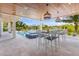 Covered outdoor kitchen with barstools and stunning water views at 111 Gull Dr, Anna Maria, FL 34216