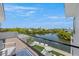 Spacious deck overlooking the water with glass railings and seating at 111 Gull Dr, Anna Maria, FL 34216