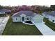Newly built home with a two-car garage and a landscaped lawn at 8233 Givlic Ln, North Port, FL 34287