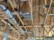 Unfinished interior with exposed wooden beams and ductwork at 8233 Givlic Ln, North Port, FL 34287