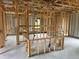 Kitchen under construction with island and unfinished cabinets at 8233 Givlic Ln, North Port, FL 34287