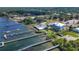 Aerial view of the docks, waterside restaurant, and waterfront residences, offering a unique coastal lifestyle at 280 Hidden Bay Dr # 203, Osprey, FL 34229