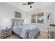 Cozy bedroom featuring light blue bedding, a wood headboard, and an inviting atmosphere at 280 Hidden Bay Dr # 203, Osprey, FL 34229