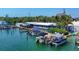 Waterfront docks with powerboats and a pontoon boat at 280 Hidden Bay Dr # 204, Osprey, FL 34229