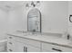 Elegant bathroom with a large mirror, white cabinetry, and marble countertop at 280 Hidden Bay Dr # 302, Osprey, FL 34229