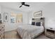 Lovely bedroom with a ceiling fan, window views, and a comfortable bed at 280 Hidden Bay Dr # 302, Osprey, FL 34229