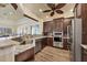 Modern kitchen featuring stainless appliances, granite counters, tile backsplash, and wood floors at 280 Hidden Bay Dr # 302, Osprey, FL 34229