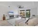 Inviting living room with plush seating, modern decor, and balcony access at 280 Hidden Bay Dr # 302, Osprey, FL 34229