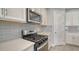 Kitchen features gray tile backsplash at 5770 Long Shore Loop, Sarasota, FL 34238