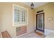 Inviting front entry with glass block window, door, and flag at 9613 Turning Leaf Ter, Bradenton, FL 34212