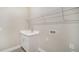 Bright laundry room with white cabinets, a utility sink, and ample shelving at 100 Corserra Dr, Nokomis, FL 34275