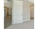 White door leading to a bedroom with carpeted floor at 100 Corserra Dr, Nokomis, FL 34275