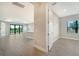 Open concept hallway offering views of the kitchen and living room at 100 Corserra Dr, Nokomis, FL 34275