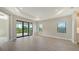 Spacious living area with sliding glass doors leading to a patio at 100 Corserra Dr, Nokomis, FL 34275