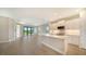 Modern kitchen with white cabinets, quartz countertops, and stainless steel appliances at 100 Corserra Dr, Nokomis, FL 34275