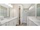 Double vanity bathroom with quartz countertops and a walk-in shower at 100 Corserra Dr, Nokomis, FL 34275
