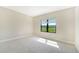 Bright bedroom with neutral walls and plush carpeting at 100 Corserra Dr, Nokomis, FL 34275