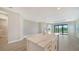 Kitchen island with white cabinetry and a quartz waterfall countertop at 100 Corserra Dr, Nokomis, FL 34275