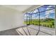 Enjoy this screened patio overlooking a peaceful backyard and water view at 100 Corserra Dr, Nokomis, FL 34275