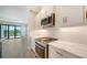 Modern kitchen with stainless steel appliances and white shaker cabinets at 100 Corserra Dr, Nokomis, FL 34275