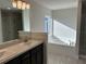 Bathroom featuring a double sink vanity, soaking tub, and light gray tile flooring at 2600 Averland Loop, North Port, FL 34287