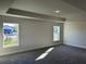Bright bedroom with large windows, plush carpet, and recessed lighting at 2600 Averland Loop, North Port, FL 34287