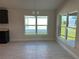 Open-concept dining area with stylish tile flooring, modern chandelier, and ample natural light at 2600 Averland Loop, North Port, FL 34287