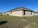 Exterior view of the house featuring a well-maintained yard and stucco walls at 2600 Averland Loop, North Port, FL 34287