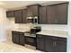 Close-up of the kitchen's stylish cabinetry, granite countertops, and modern stainless steel appliances at 2600 Averland Loop, North Port, FL 34287