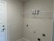 A functional laundry room with shelving for storage and ample outlets for appliances at 2600 Averland Loop, North Port, FL 34287