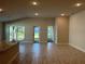 Bright living room with tile floors, recessed lighting, granite bar, and sliding glass door to the backyard at 2600 Averland Loop, North Port, FL 34287
