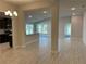 Open-concept living area featuring stylish tile flooring, recessed lighting, and a view into the kitchen at 2600 Averland Loop, North Port, FL 34287