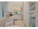 Modern white kitchen with breakfast bar and built-in shelving at 6285 Midnight Pass Rd # 309, Sarasota, FL 34242