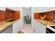 Open kitchen with granite countertops, white cabinets, and a view of the dining area at 5641 Midnight Pass Rd # 902, Sarasota, FL 34242