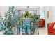 Bright dining area with glass-top table and four teal chairs at 5641 Midnight Pass Rd # 902, Sarasota, FL 34242