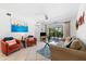 Living room with comfortable seating, a coffee table, and access to a balcony at 5641 Midnight Pass Rd # 902, Sarasota, FL 34242