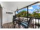 Small balcony with table and chairs, screened-in at 5641 Midnight Pass Rd # 902, Sarasota, FL 34242