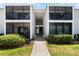 Front view of condo building with walkway and landscaping at 5641 Midnight Pass Rd # 902, Sarasota, FL 34242