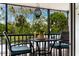 Private screened balcony overlooking lush tropical landscaping at 5641 Midnight Pass Rd # 902, Sarasota, FL 34242