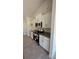 White shaker cabinets, granite countertops, and stainless steel appliances in the kitchen at 2593 Englewood Rd, Venice, FL 34293