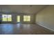 Bright and spacious living area with large windows and tile flooring at 2593 Englewood Rd, Venice, FL 34293