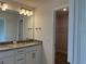 Bathroom featuring double vanity, granite counters, and a walk-in closet at 855 Cumberland Rd, Venice, FL 34293