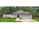 One-story home with gray siding, dark roof, and two-car garage at 855 Cumberland Rd, Venice, FL 34293
